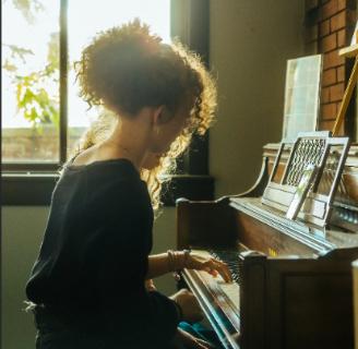 Student at piano exploring their gifts