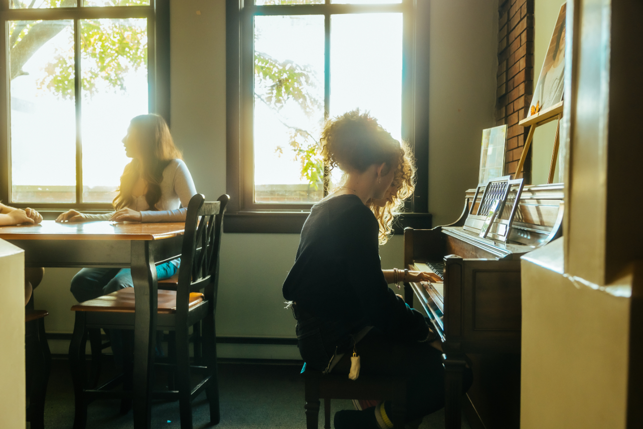 Students at City School playing piano and learning